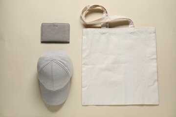 Different blank items for branding on beige background, flat lay. Mockup for design