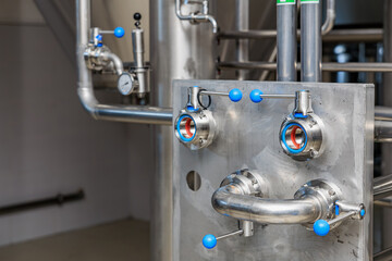 Industrial brewery equipment with stainless steel valves and pipes