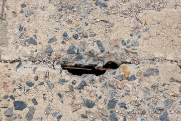 Close-up of damaged concrete surface with crack