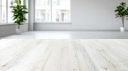 Fototapeta premium White wooden table in bright office, plants blurred background; product display