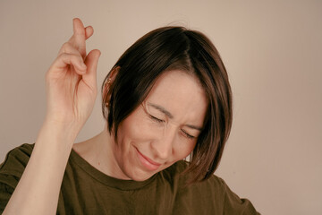 A beautiful brunette girl in a swamp t-shirt stands with her head bowed, smiling and raising her...