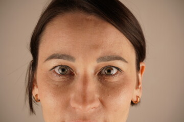 Close-up photo of beautiful gray female eyes looking directly into the camera. Close the eyes of a...