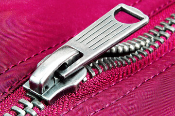 Zipper with one metal runner. Elements of clothing. Close-up