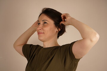 Beautiful casual woman is touching her ear. Health concept.