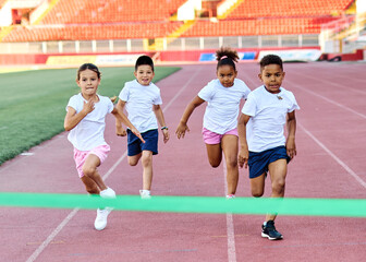 child sport athlete competition running race exercise sprinting speed runner achievement finish line celebration challenge champion goal ribbon success