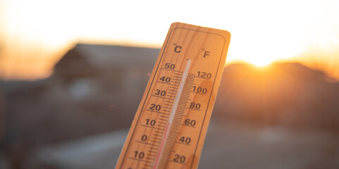 Thermometer on sky background. Sunset. Weather