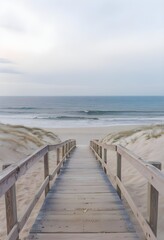 Obraz premium Wooden Deck Extending Out to the Beach with Dark Blue Waters and Tranquil Seaside Vibes