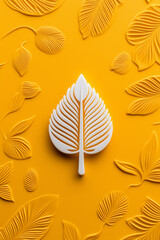 White leaf on yellow textured background with embossed leaf pattern.