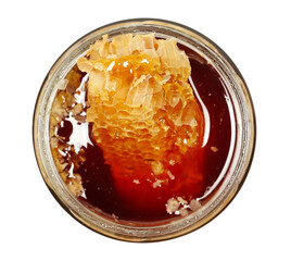 Jar of honey with honeycomb isolated on white background, top view
