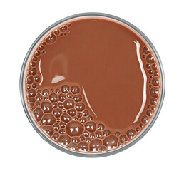 Chocolate milk puddle in glass isolated on white, top view