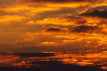 beautiful and dramatic sunset sky with bright yellow clouds as abstract background