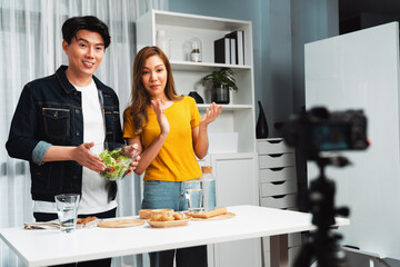 Cooking show live streaming with two chef influencers making mixed salad, all ingredients with...