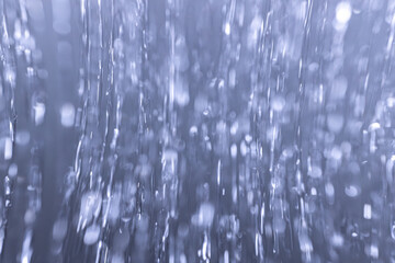 Artistic capture of flowing water with motion blur and monochrome tones. Features geometric...