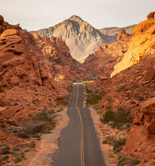 The sunrise light illuminates the red rock valley at Mouse Tank Road in the Valley of Fire state park in Nevada
