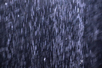 Artistic capture of flowing water with motion blur and monochrome tones. Features geometric...
