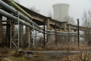 Massive concrete cooling tower in an abandoned industrial area