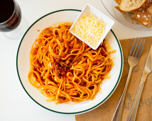 Italian tallarines bolonesa, bolognese noodles with tomato sauce and cheese in a cafe