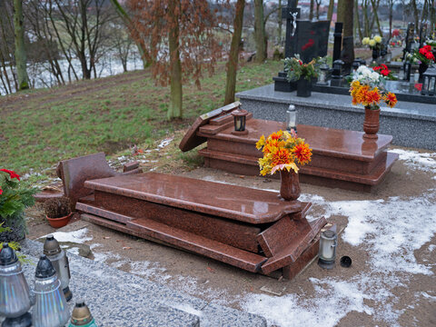 New damaged tombstones at a Christian cemetery in Poland.