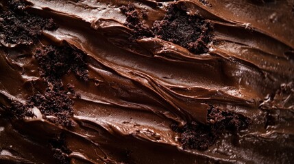 Fototapeta premium Close up of a dark chocolate cake with a rich frosting texture and cake crumbs on the surface