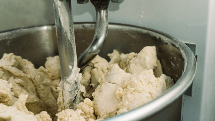 
The process of kneading dough in an industrial spiral dough mixer. Preparing dough for cooking....
