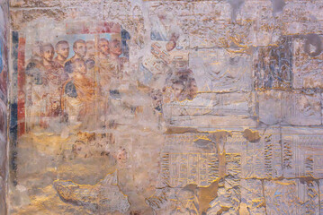 Ancient Roman fresco depicting a group of men in togas, possibly officials or dignitaries, with faded details shwoing older Egyptian carvings