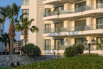 Modern architecture showcases luxury living by the coastal palm trees at sunset in a serene urban landscape