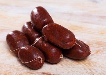 Blood sausage black pudding on wooden background