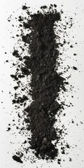 Fototapeta premium A vertical line of dark soil with scattered particles on a white background.