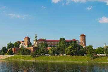 Explore the historic Wawel Castle in Krakow overlooking the Vistula River under a clear blue sky
