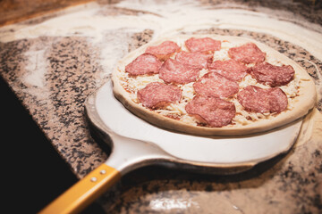 Pepperoni salami pizza on a shovel
