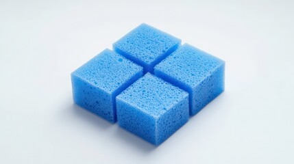 Four light blue porous square sponges arranged in a cross shape on a white background.