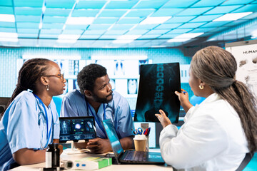 African american medical staff preparing before a consultation in an office, combining advanced technology tools with their expertise. Teamwork to deliver great healthcare services.
