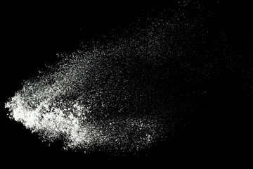 Fluffy White snow splash flying or throwing in mid air. Snowfall on Black background isolated. Snow...