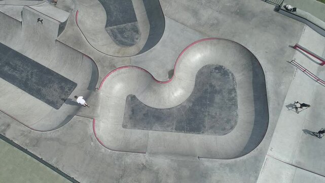 Skate park with a large half pipe and a smaller ramp. A person is riding a skateboard on the half pipe. The city of Nizhny Novgorod, near the Oka River. Russia