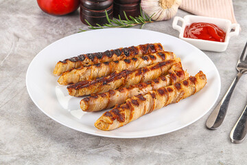 Grilled meat sausages wrapped bacon