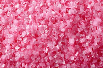 Fototapeta premium Close-up view of shimmering pink candy sprinkles forming an appealing textured background