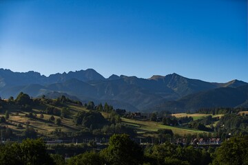 Breathtaking view of mountain range under clear blue sky during early morning light in a serene landscape setting