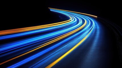 Abstract light trails of cars on a curved road at night.