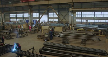 An Industrial Workshop with Machinery and Workers engaged in various collaborative tasks. Media