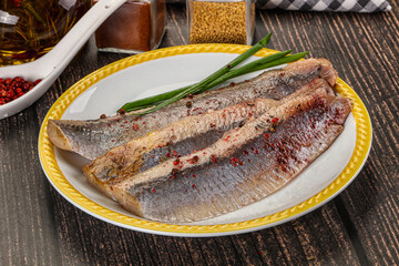 Salted marinated herring fillet with spices