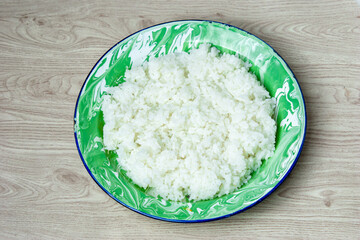Rice on the green old plate on the table