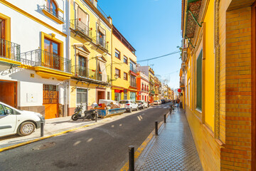 Fototapeta premium The colorful buildings along the main Calle Pureza street in the historic Triana District of the Andalusian city of Seville, Spain. 
