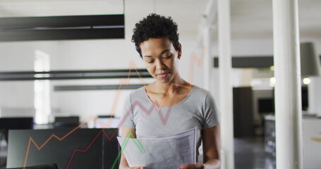 Image of financial data processing over biracial businesswoman in office