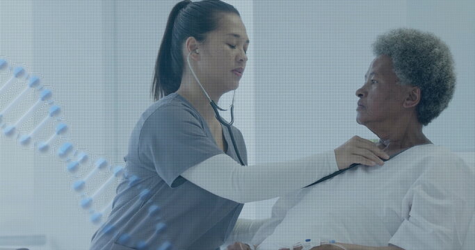 Image of dna strand over diverse female doctor using stethoscope on throat of senior patient