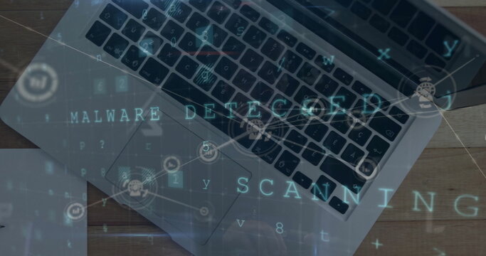 Image of malware detected text with network and data processing over laptop on desk