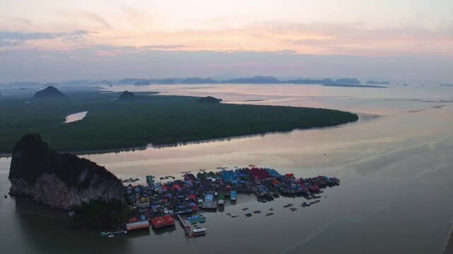 Aerial view Hyperlapse of Panyee island in Phang Nga Thailand,High angle view Floating village,Koh Panyee fishing village island in Phang Nga, Thailand,Timelapse sky sunrise clouds over sea