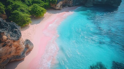 Aerial view of a tropical beach with pink sand and turquoise water surrounded by cliffs