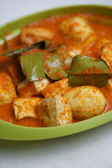 Eggs and tofu balado with spices and lime leaves. Indonesian cuisine. Focus selected