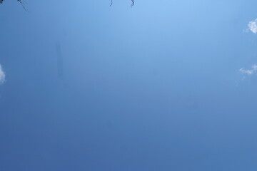 Summer blue sky, rainy season, gradient clouds, bright white and blue background. The beauty of bright clouds in the sun, the calm and clear winter air. The gloomy blue-green landscape in the environm