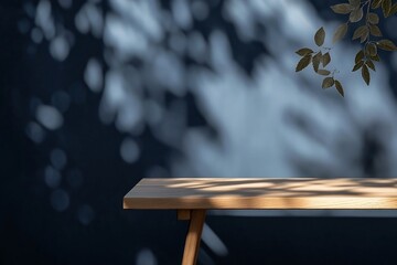 Empty wooden table with sunlight and leaves shadow on blurred background.